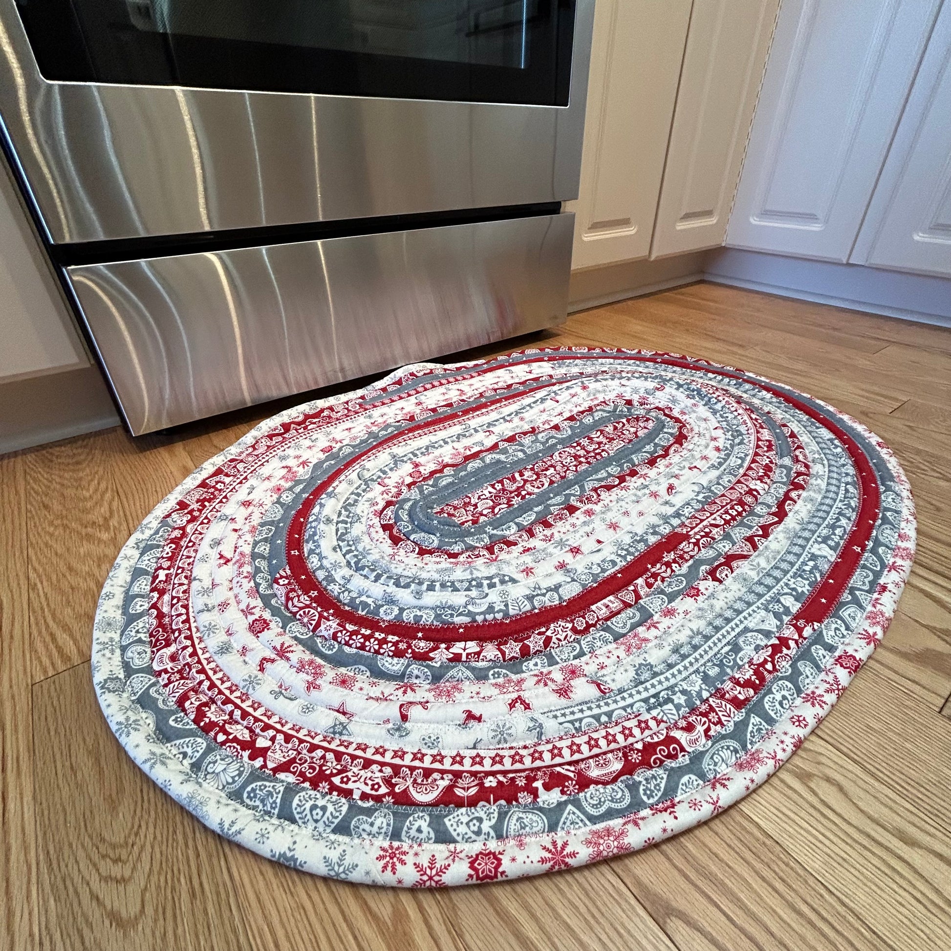 Scandinavian Christmas Print Handmade Cotton Jelly Roll Rug for Kitchen, Luxury Bathmat or Bedside Rug. Washable and reversible, this is a cozy cotton rug that will wash and wear for years to come. Made in Canada by Home Stitchery Decor