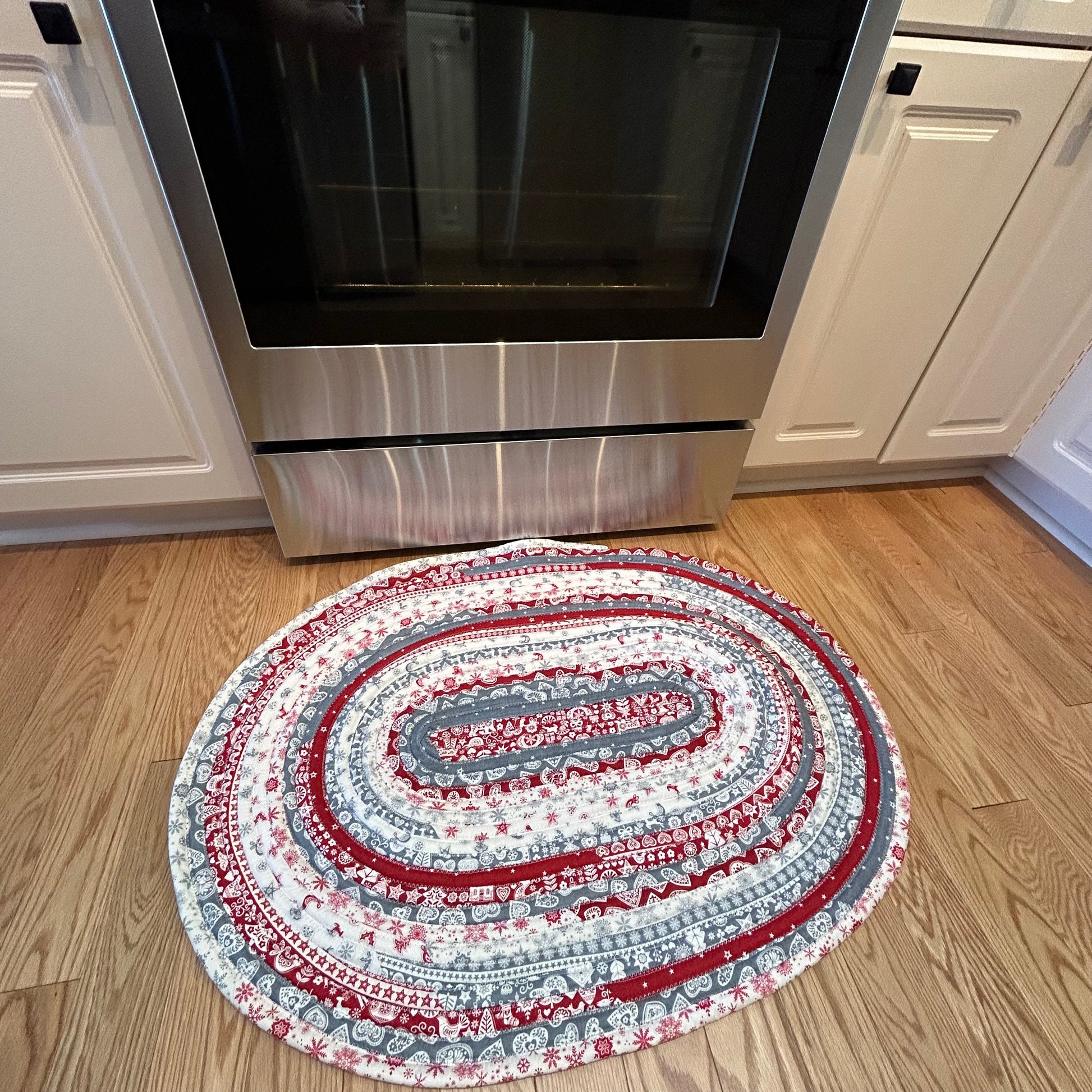 Scandinavian Christmas Print Handmade Cotton Jelly Roll Rug for Kitchen, Luxury Bathmat or Bedside Rug. Washable and reversible, this is a cozy cotton rug that will wash and wear for years to come. Made in Canada by Home Stitchery Decor