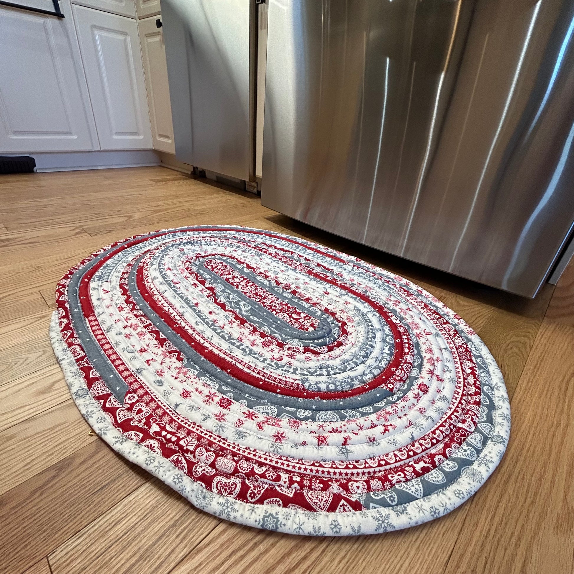 Scandinavian Christmas Print Handmade Cotton Jelly Roll Rug for Kitchen, Luxury Bathmat or Bedside Rug. Washable and reversible, this is a cozy cotton rug that will wash and wear for years to come. Made in Canada by Home Stitchery Decor