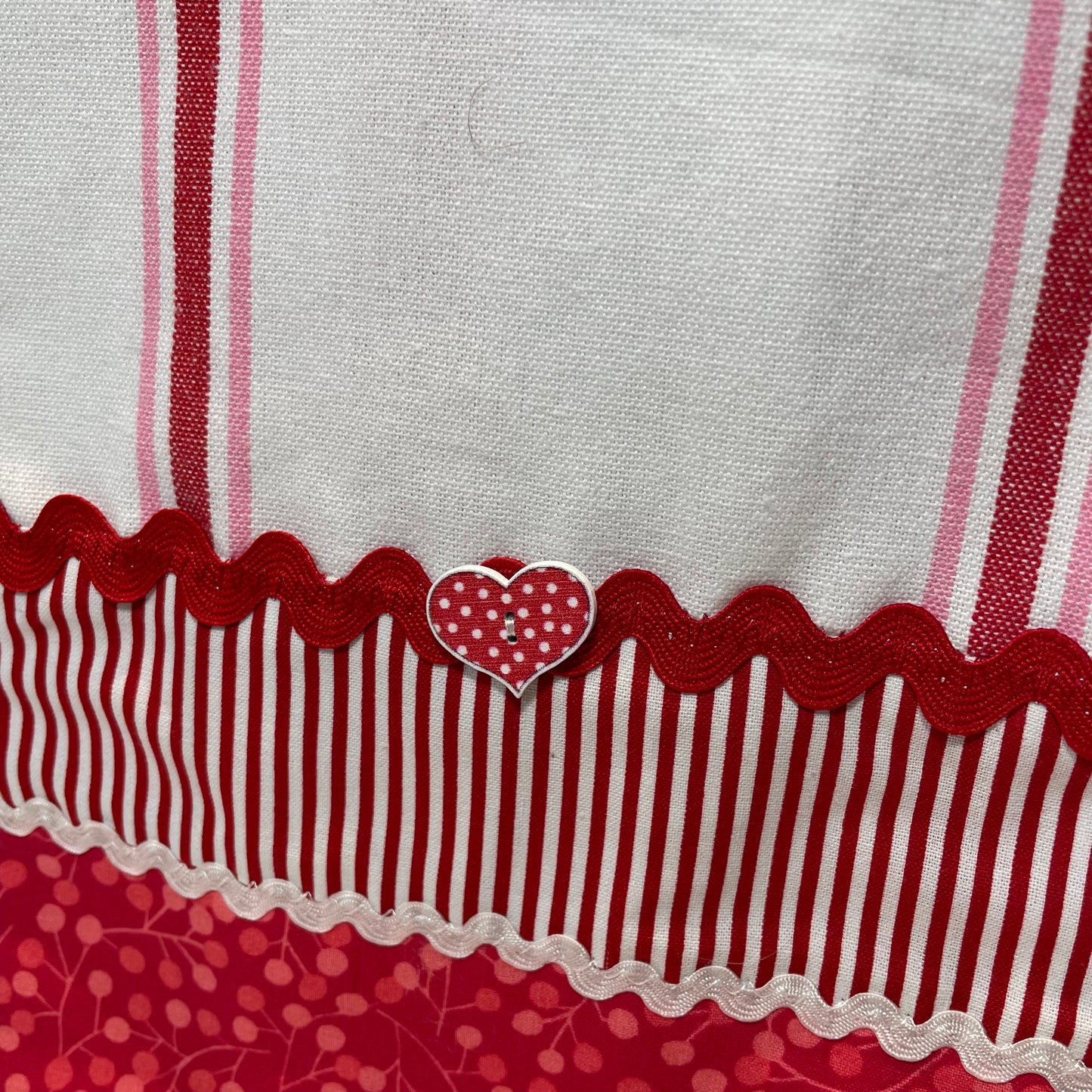 Cute red, white and pink towel with handcrafted quilting cotton accents. Featuring red Ric Rac, white Ric Rac and and heart shaped button. Part of a mix and match collection of coordinated kitchen and bath decor. Browse your favorites and be sure to follow along on the Home Stitchery Decor YouTube Channel